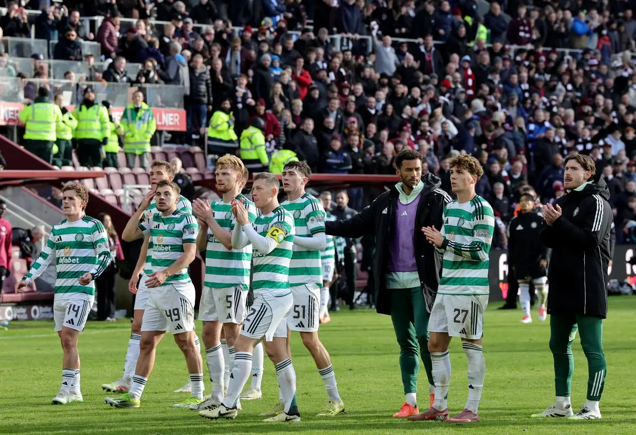 Celtic players applaud the club's fans following their defeat against Hearts 