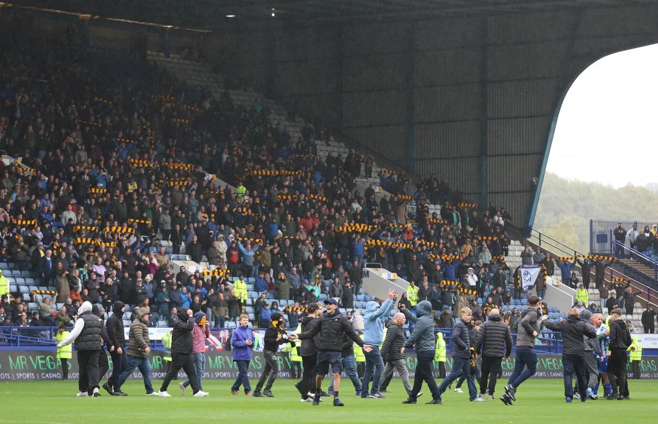 Sheffield Wednesday fans invade the pitch in protest against the club’s owner Dejphon Chansiri during Saturday's defeat to Coventry
