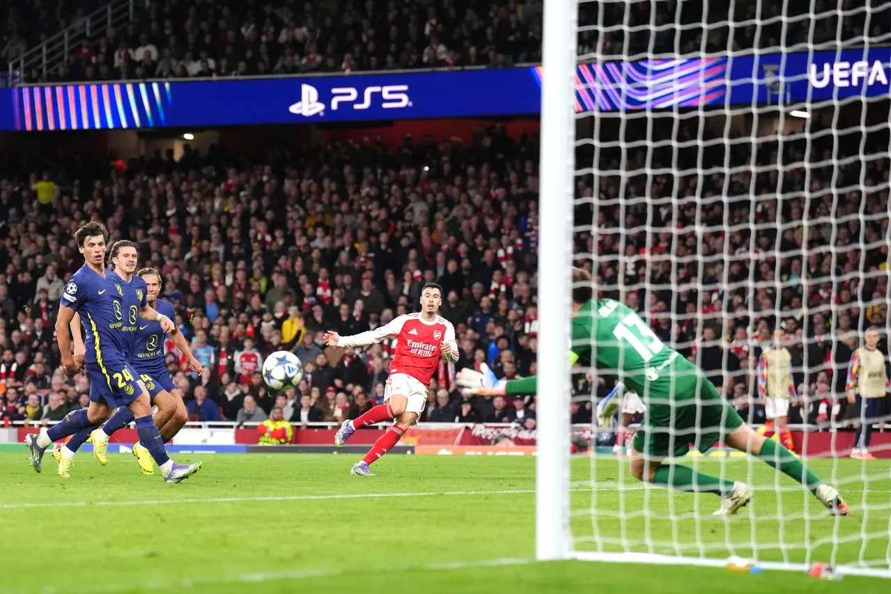 Gabriel Martinelli, centre, curls in Arsenal’s second goal