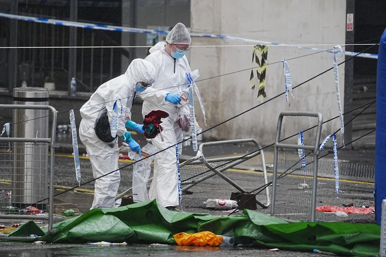 Forensic officers at the scene in Water Street near the Liver Building in Liverpool after the victory parade