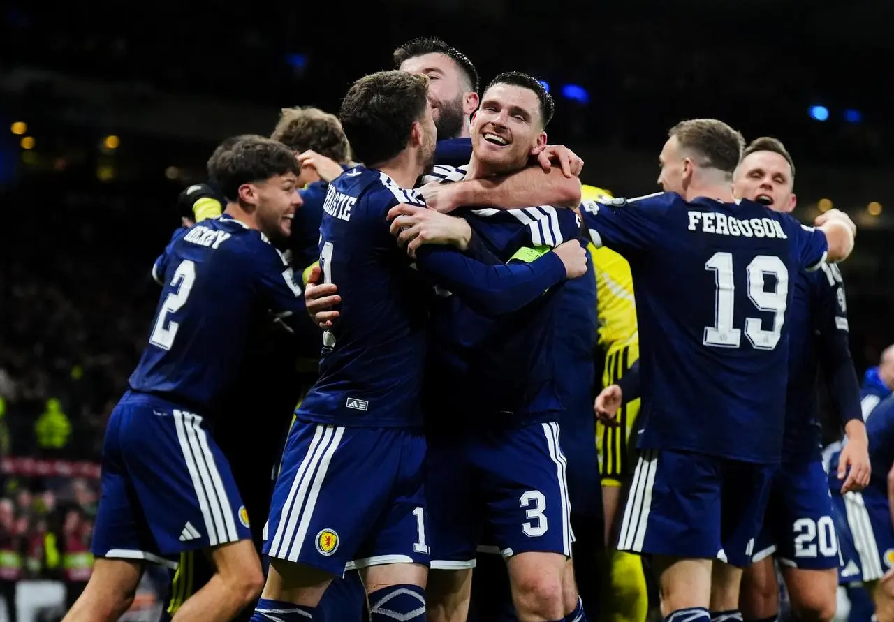 Andy Robertson and Ryan Christie embrace as the Scotland players celebrate
