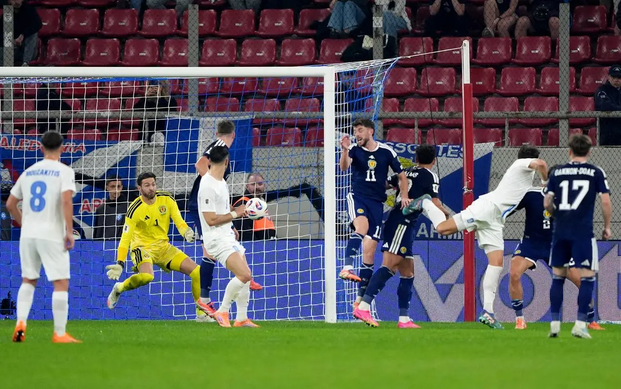 Craig Gordon makes a save in Greece