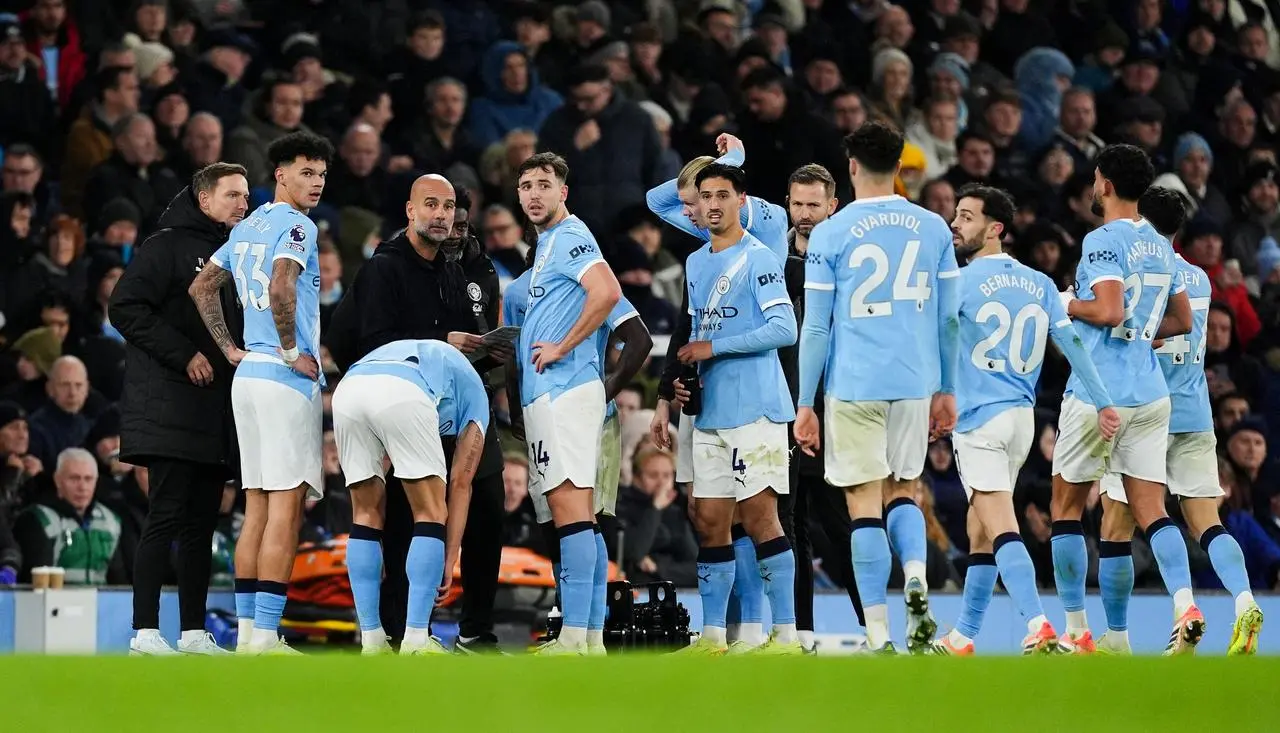 Manchester City manager Pep Guardiola with his players during the Premier League match against Leeds