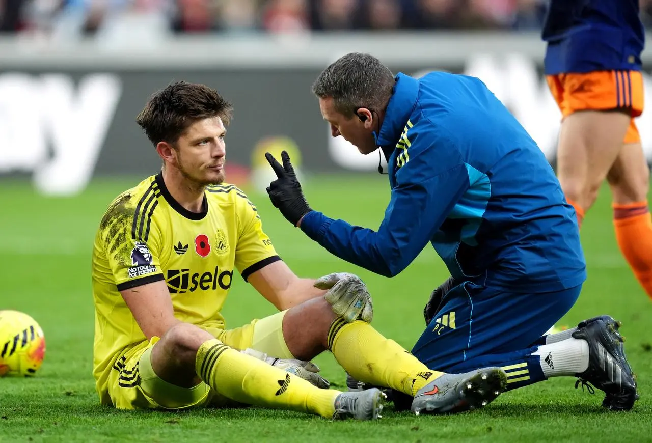 Newcastle goalkeeper Nick Pope receives treatment at Brentford