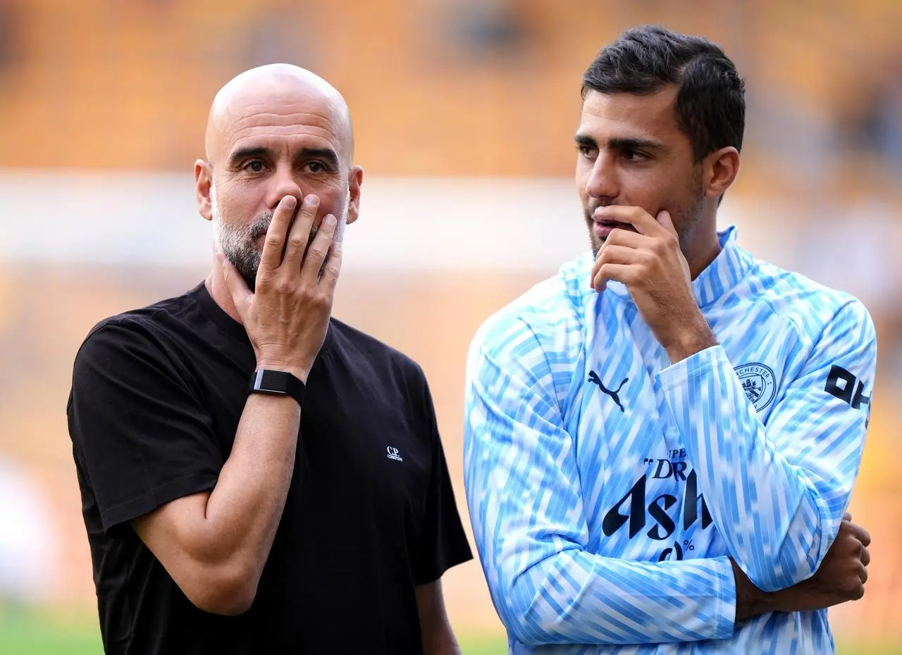 Manchester City manager Pep Guardiola and Rodri stood together before a game