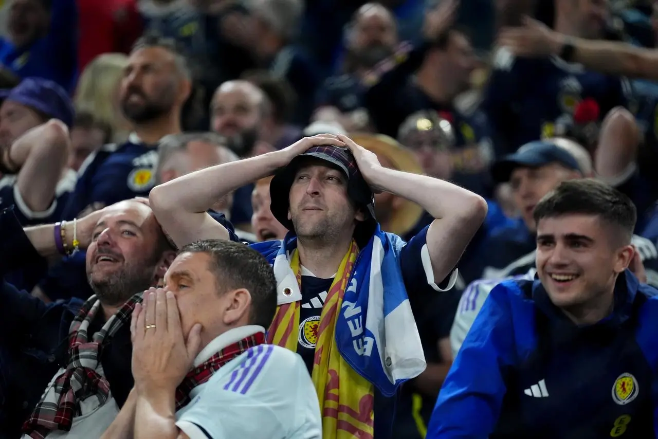 Scotland fans react to a missed chance in Greece