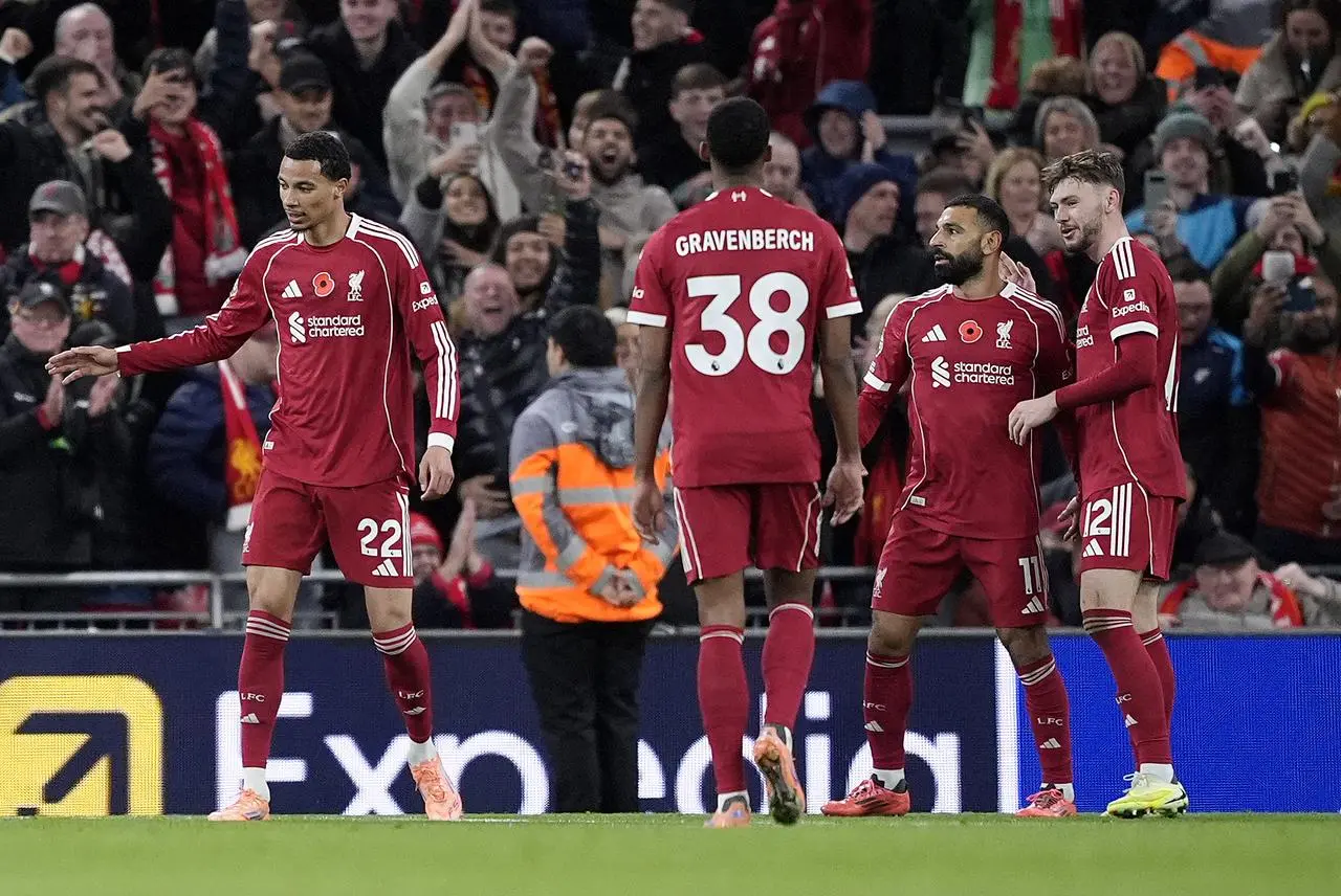 Liverpool’s Mohamed Salah (second right) celebrates with team-mates after scoring against Aston Villa