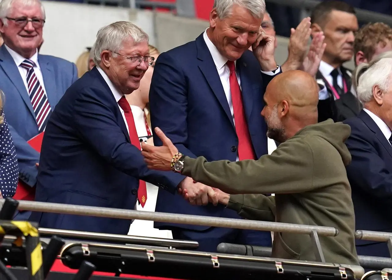 Sir Alex Ferguson, left, shakes hands with Pep Guardiola