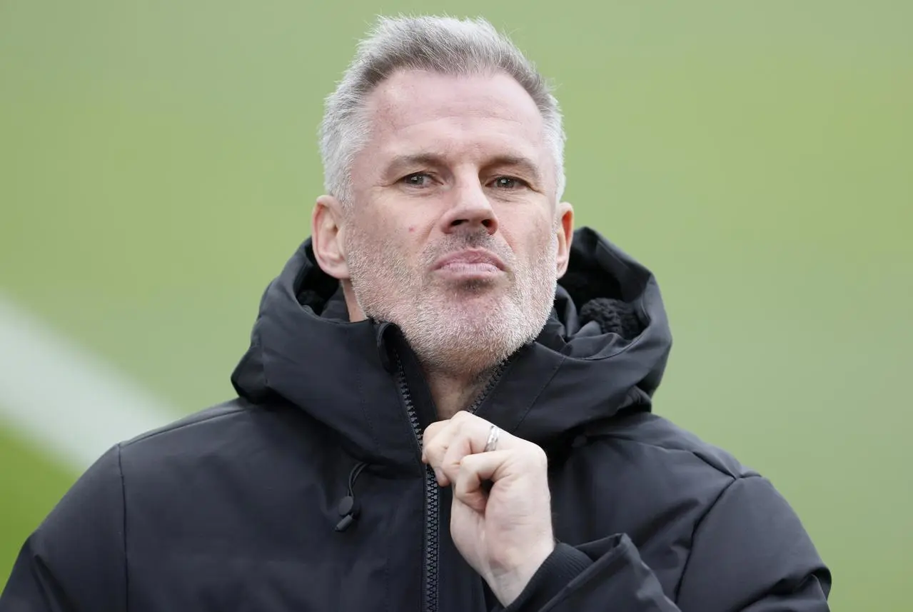 Sky pundit Jamie Carragher zips his coat up to his neck