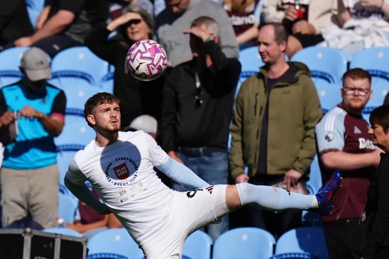 Aston Villa’s Harvey Elliott warms up in front of fans in the stand