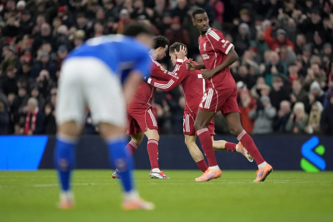 Florian Wirtz, centre, celebrates with Curtis Jones after Liverpool's goal against Sunderland, with Alexander Isak seen in the foreground