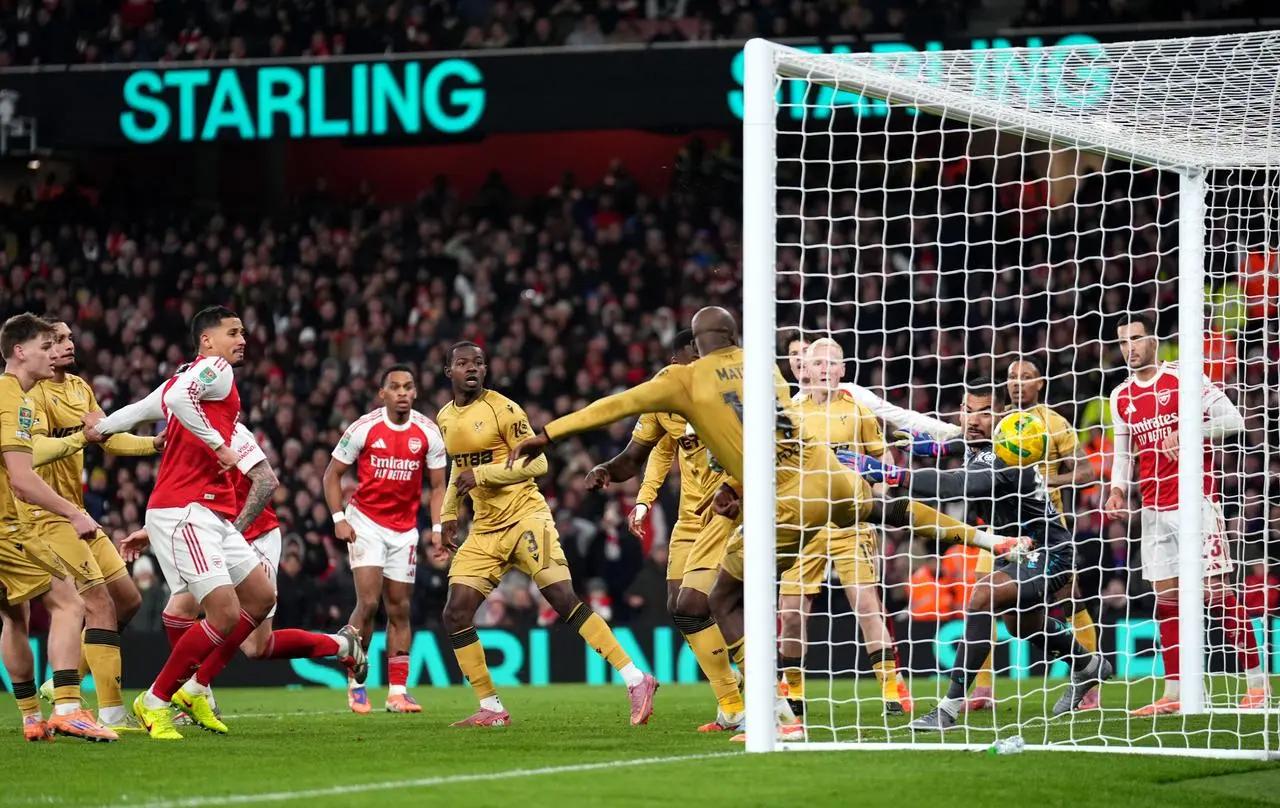 Crystal Palace’s Maxence Lacroix, obscured, scores an own goal to give Arsenal the lead