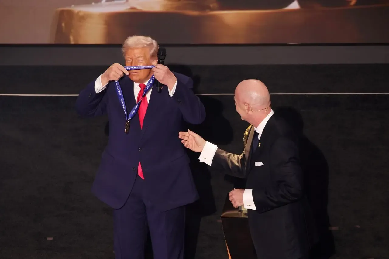 Donald Trump puts on a medal for winning the FIFA peace prize