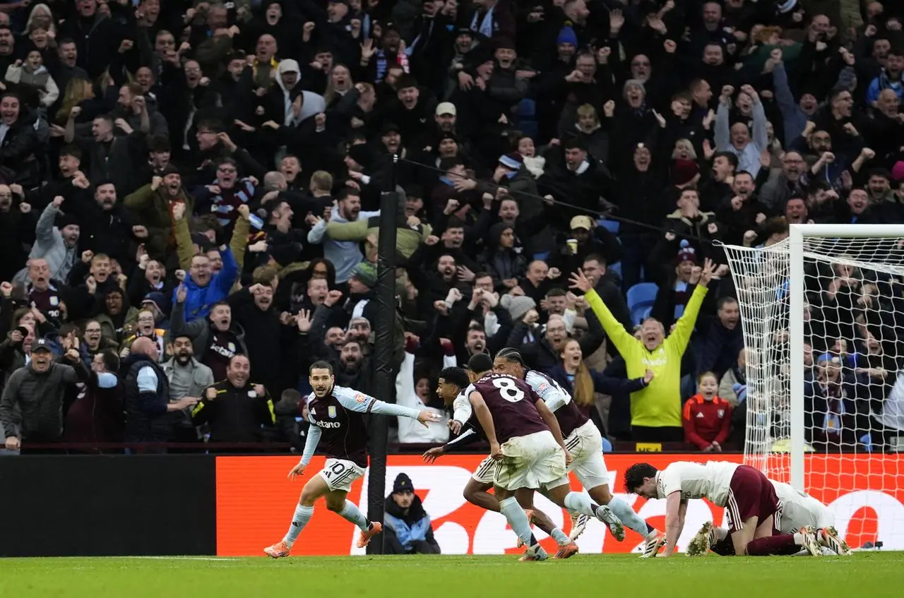 Emiliano Buendia, left, and Aston Villa celebrates their late winner against Arsenal