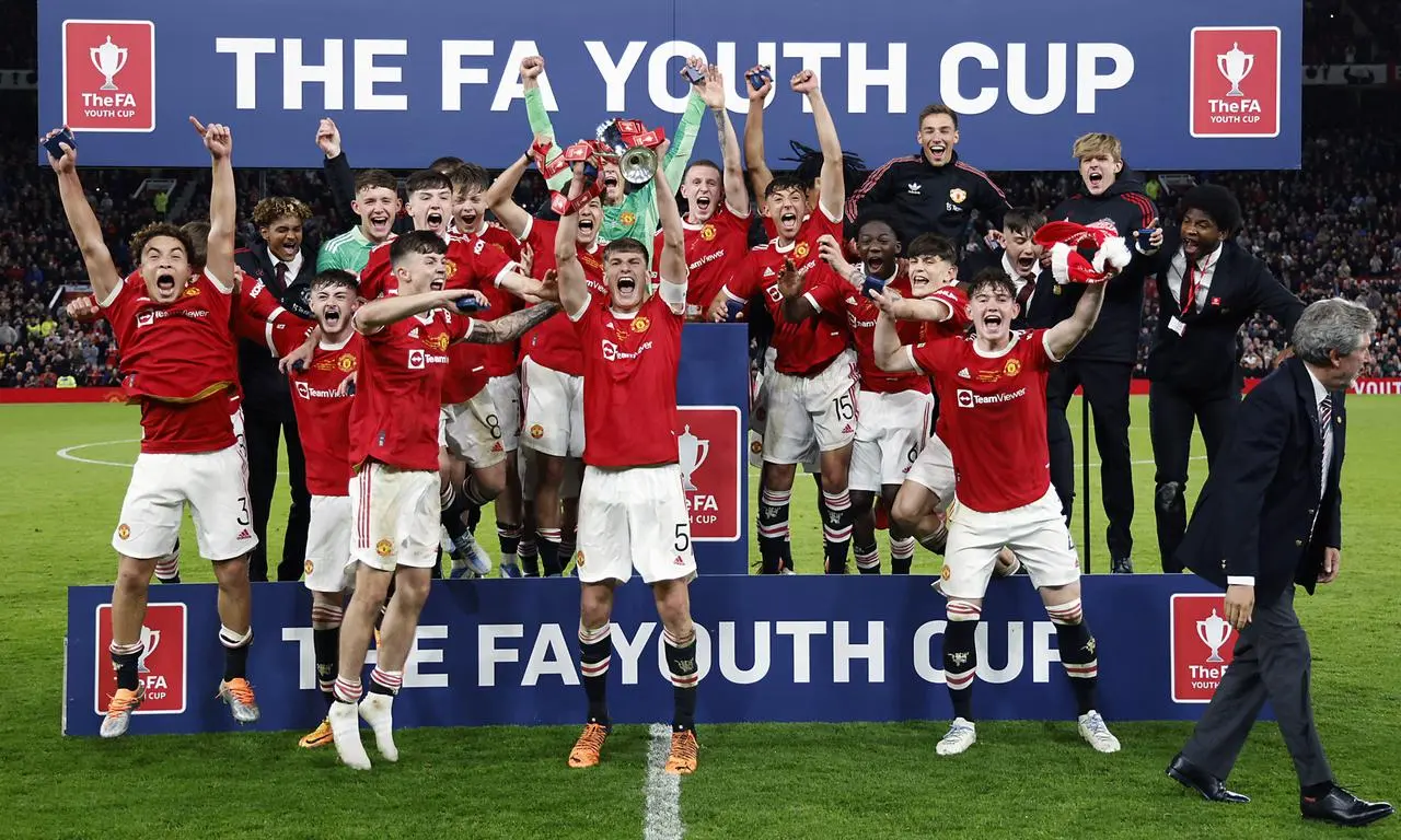 Rhys Bennett lifts the FA Youth Cup at Old Trafford in 2022