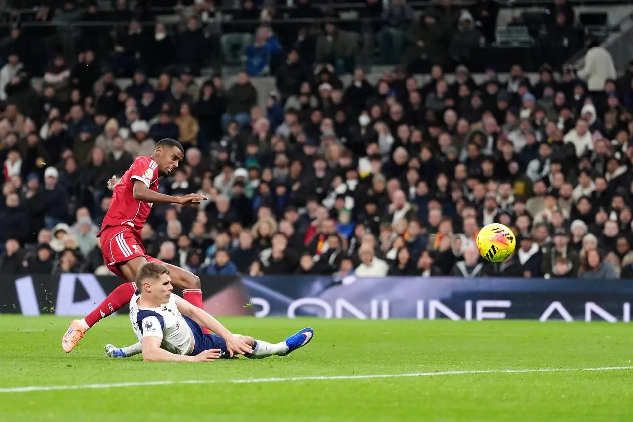 Alexander Isak (left) scores Liverpool's first goal at Tottenham