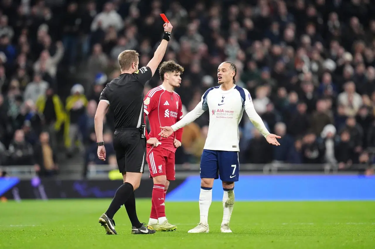 Xavi Simons is shown a red card