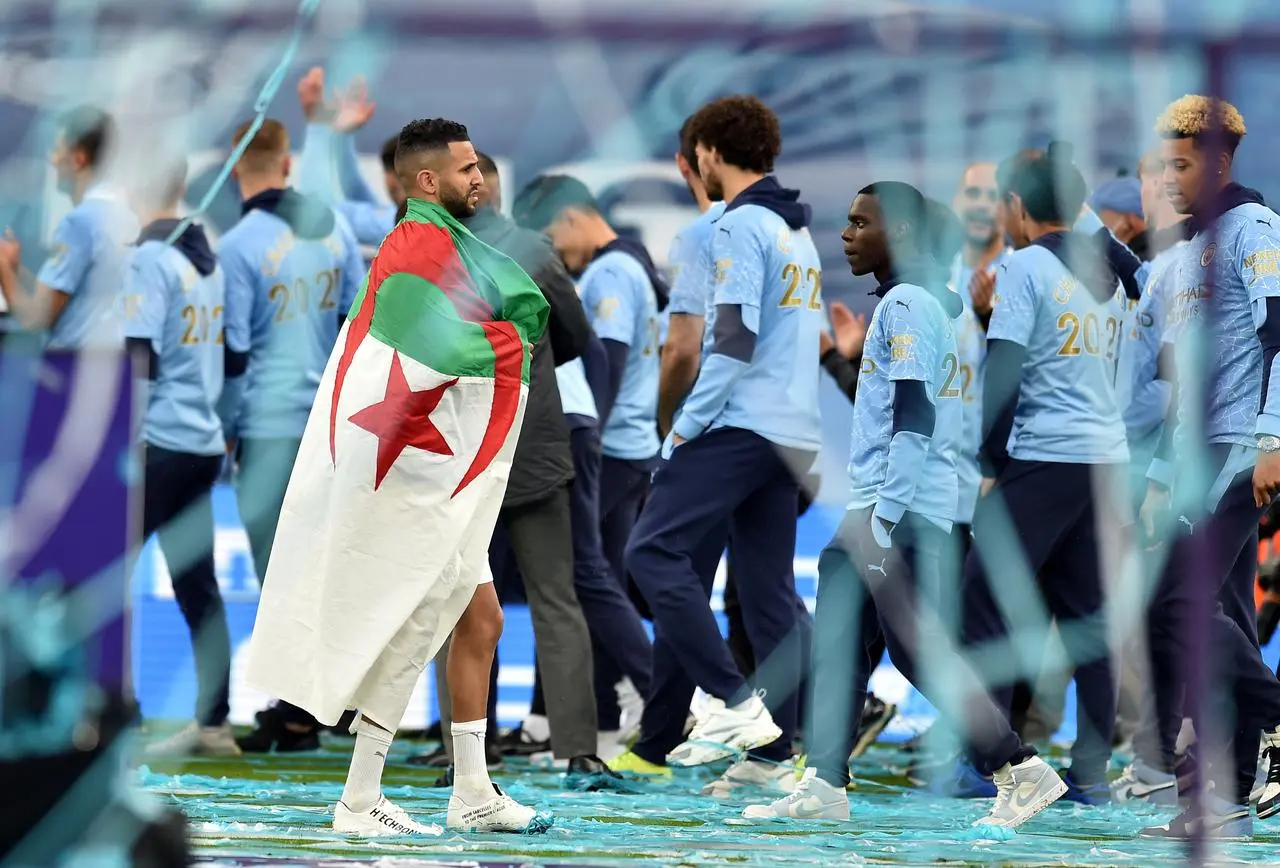 Former Manchester City midfielder Riyad Mahrez with the flag of Algeria after a Premier League match against Everton