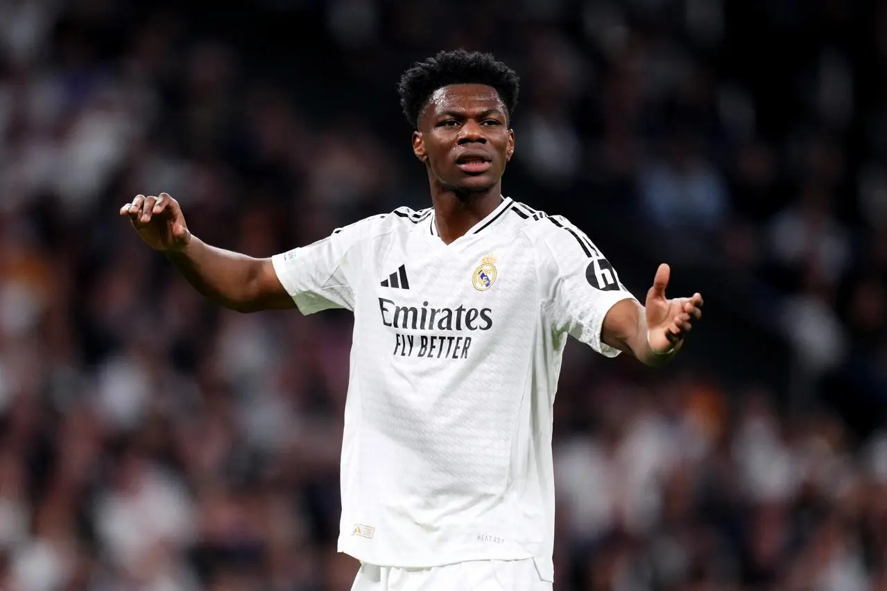 Aurelien Tchouameni holds out his arms