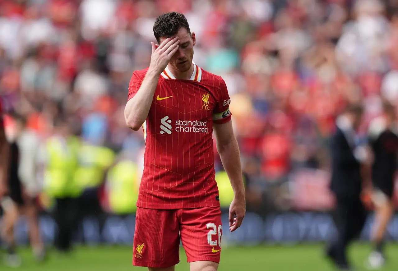 Liverpool defender Andy Robertson puts his hand to his forehead 