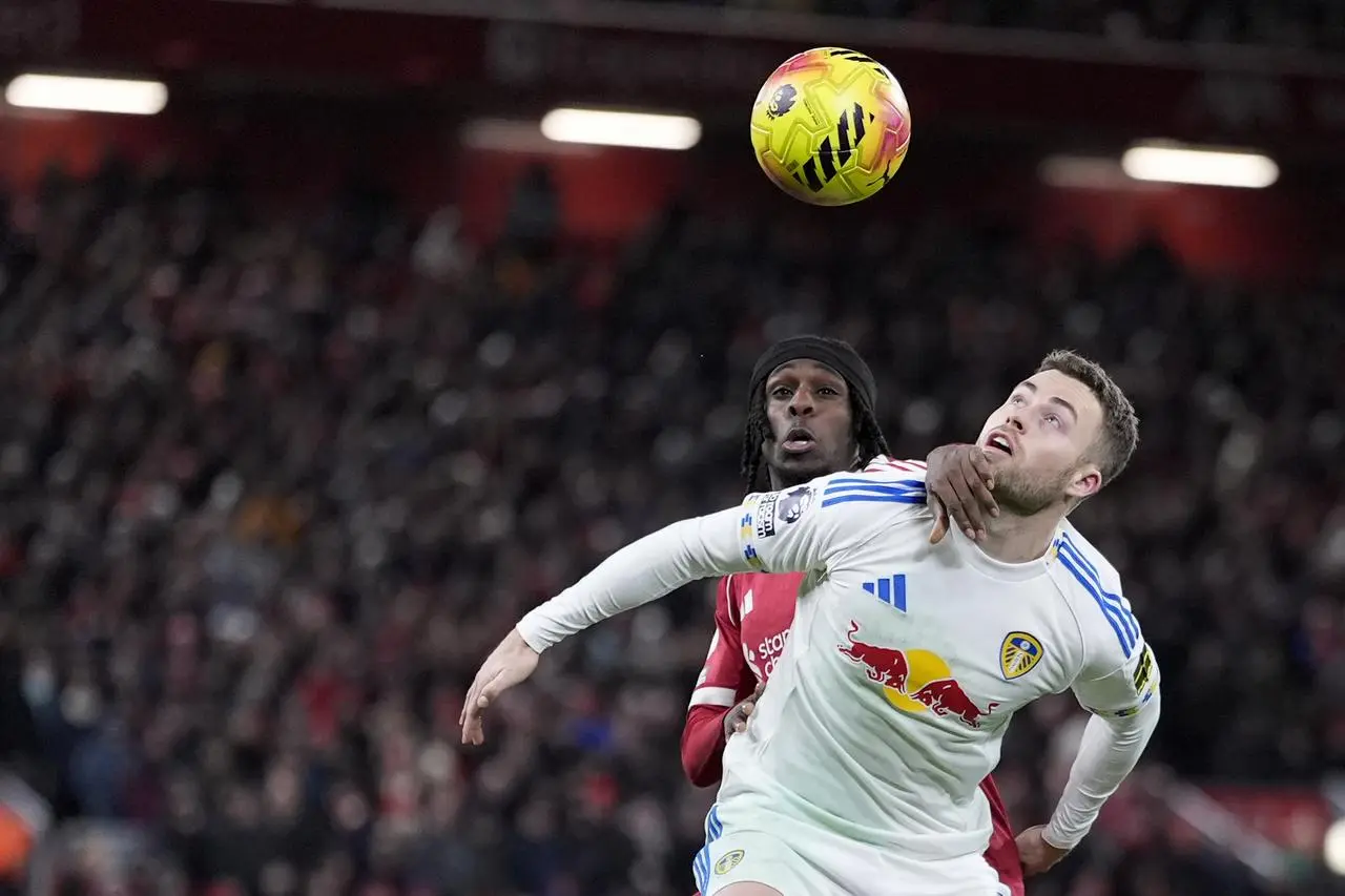 Liverpool’s Jeremie Frimpong (left) and Leeds’ Gabriel Gudmundsson (right) battle for the ball 