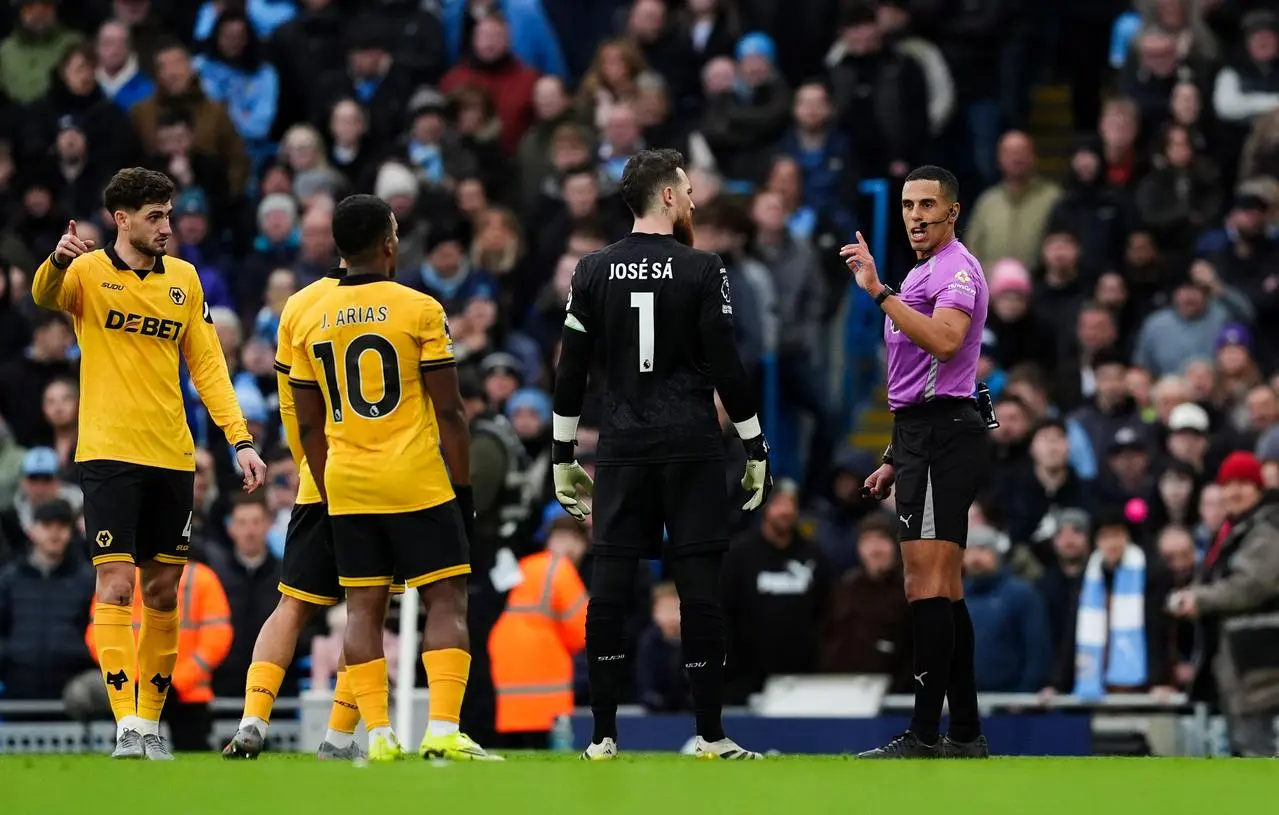 Referee Farai Hallam makes an announcement of no penalty following a VAR review 