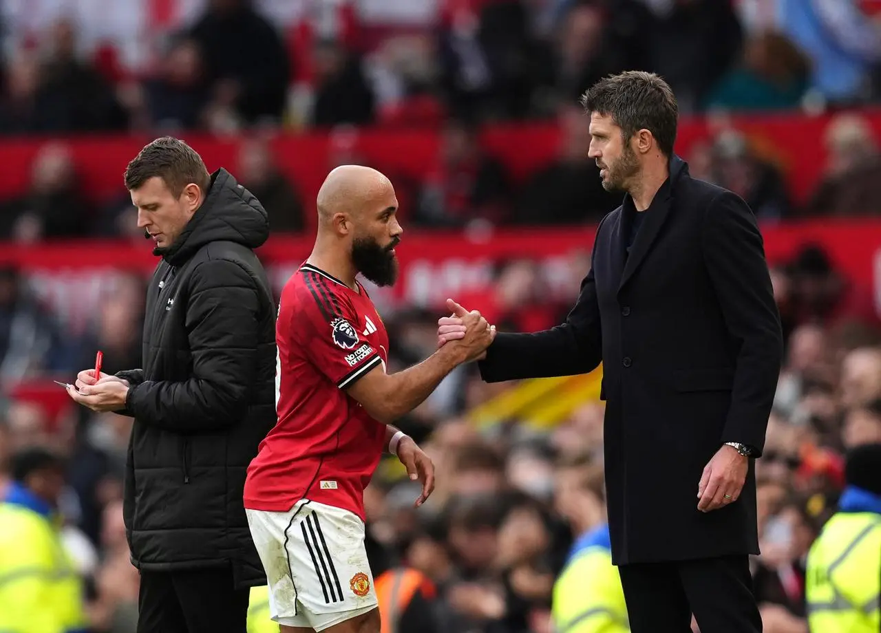 Manchester United’s Bryan Mbeumo greets interim head coach Michael Carrick as he is substituted 