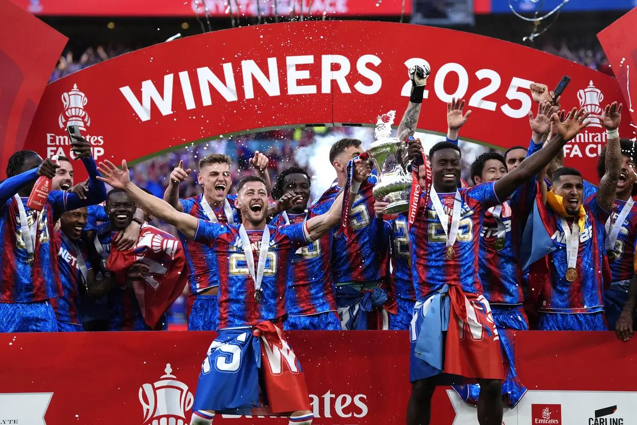 Crystal Palace’s Joel Ward and Mark Guehi celebrate with the trophy following their FA Cup final win last year