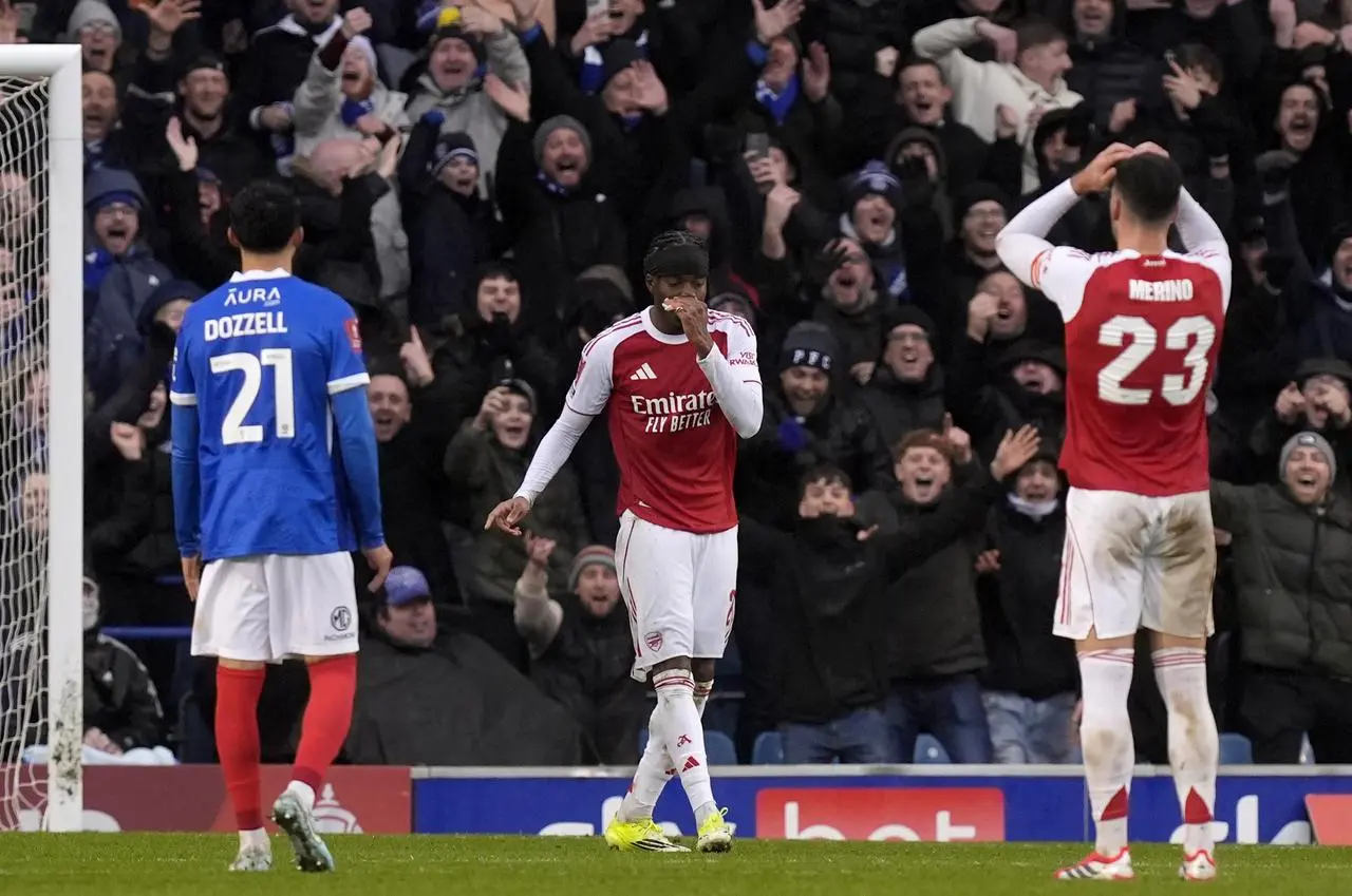 Arsenal’s Noni Madueke, centre, reacts after missing a penalty against Portsmouth