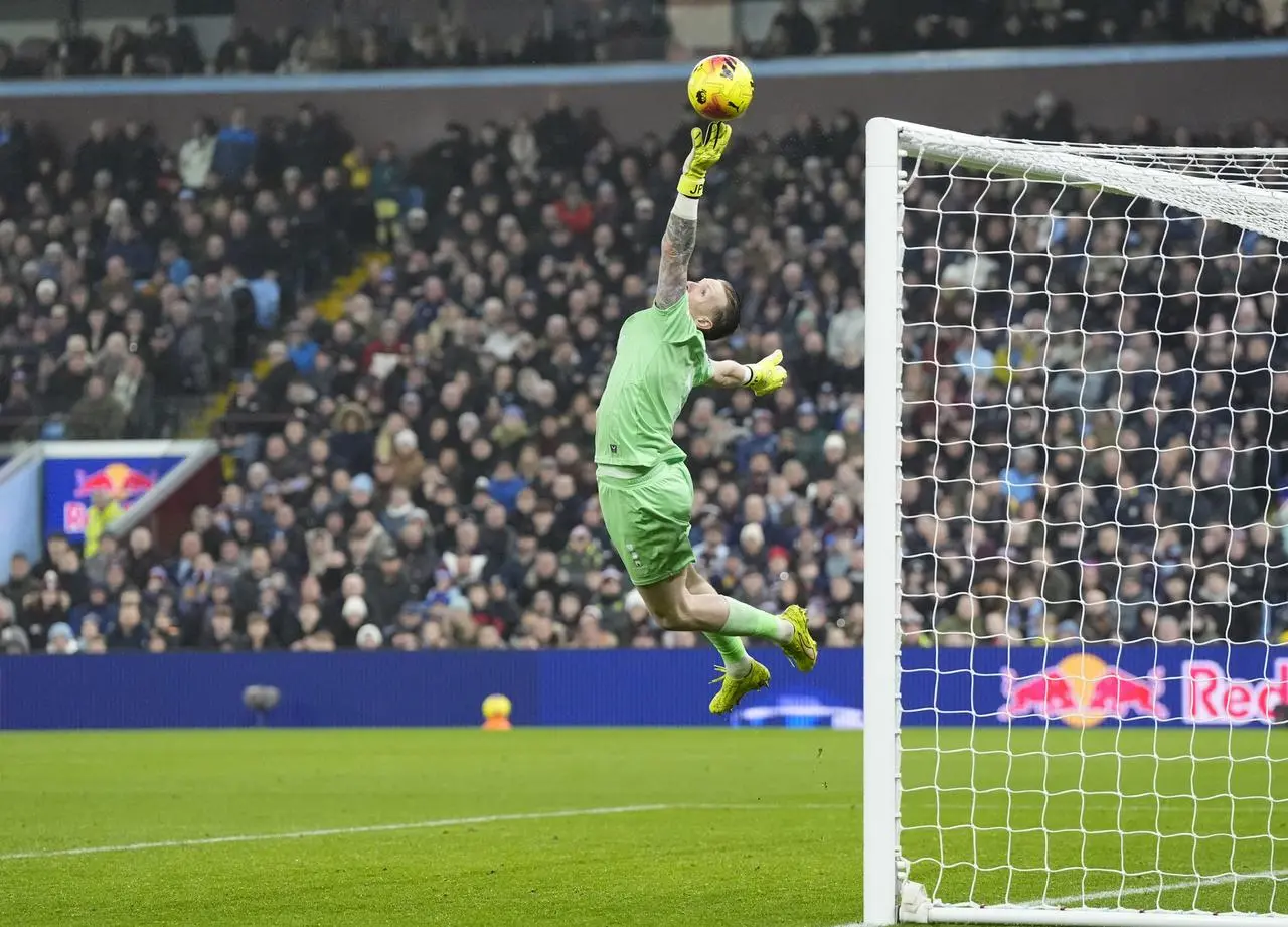 Everton goalkeeper Jordan Pickford makes a save from a shot from Aston Villa’s Morgan Rogers (not pictured)