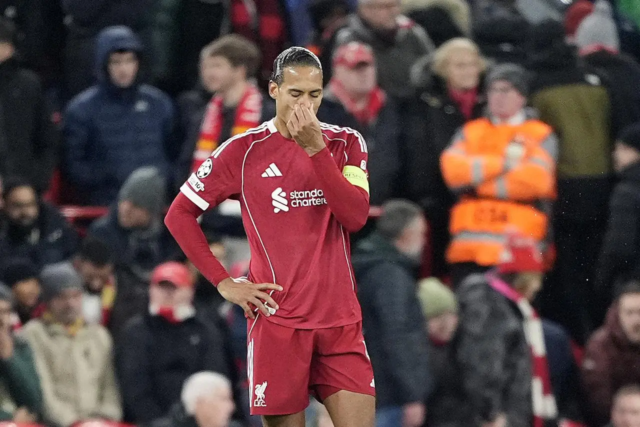 Liverpool captain Virgil van Dijk covers his mouth with his hand