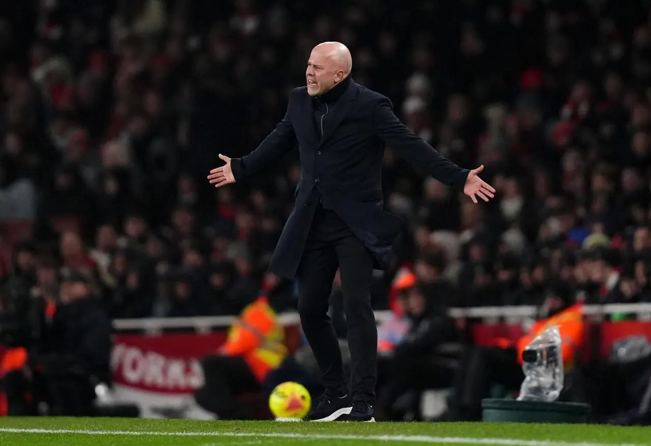 Liverpool head coach Arne Slot stands on the touchline with his arms outstretched