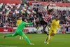 Brentford striker Ivan Toney does battle with Liverpool's Virgil Van Dijk and Alisson Becker