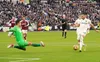 Jack Harrison nets his hat-trick goal past the on-rushing Lukasz Fabianski