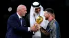 FIFA president Gianni Infantino, left, and The Emir of Qatar, Sheikh Tamim bin Hamad Al Thani, present Argentina captain Lio