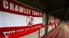 A general view of Crawley Town flags attached to an empty terrace inside the ground before the Sky Bet League Two match at T