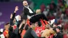 Morocco boss Walid Regragui is held aloft by his players (Martin Meissner/AP)