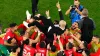 Morocco head coach Walid Regragui is held aloft by his players after their upset win over Spain (Petr David Josek/AP)