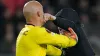 A PSV supporter punches Sevilla’s goalkeeper Marko Dmitrovic in the face 