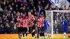 Brentford players celebrate after Chelsea’s Cesar Azpilicueta own goal