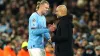 Manchester City’s Erling Haaland, left, with Pep Guardiola (Martin Rickett/PA)