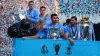 Manchester City’s players were flanked by thousands of fans as the team celebrated their treble triumph with an open-top bus