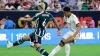 Real Madrid’s Jude Bellingham, right, chips the ball over Manchester United defender Lisandro Martinez for a goal during the