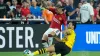 Borussia Dortmund’s Ramy Bensebaini tackles Manchester United’s Antony (John Locher/AP)