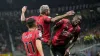 Theo Hernandez, centre, celebrates with Rafael Leao, right, after scoring Milan’s third (Luca Bruno/AP)