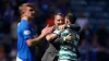 Celtic manager Brendan Rodgers celebrates with Greg Taylor after victory at Ibrox (Andrew Milligan/PA)