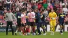 Both teams clash after Dan Neil is sent off (PA)