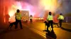 Police officers with dogs as flares are set off outside the stadium before the UEFA Europa Conference League Group E match a