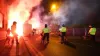 Police officers with dogs as flares are set off outside Villa Park (David davies/PA)