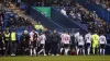 Players leave the pitch after the match was halted due to a medical condition (Richard Sellers/PA)